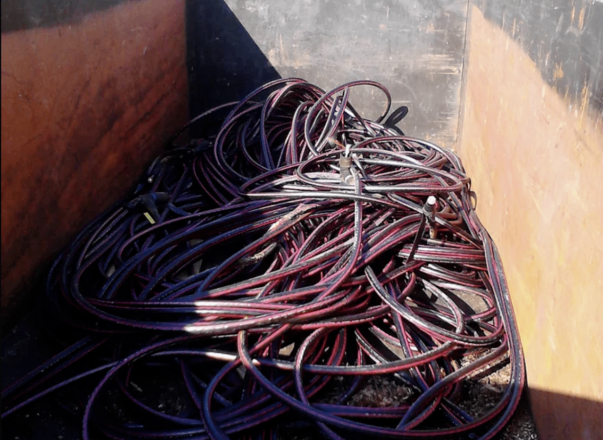 Coils and cut lengths of insulated copper wire packed on a pallet for container shipping